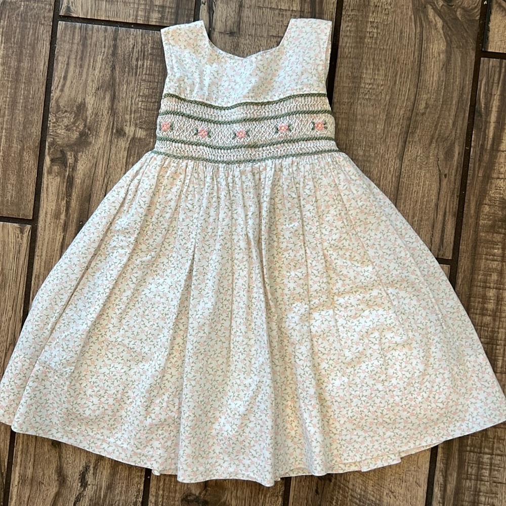 Beautifully crafted Strasburg smocked dress with tie back.